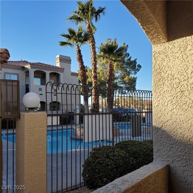 view of swimming pool featuring a fenced in pool, a patio, and fence