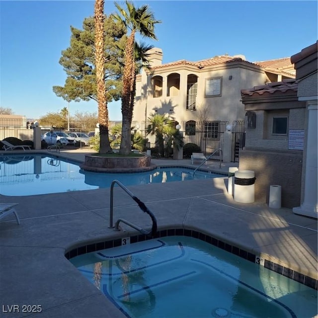 community pool with fence and a patio