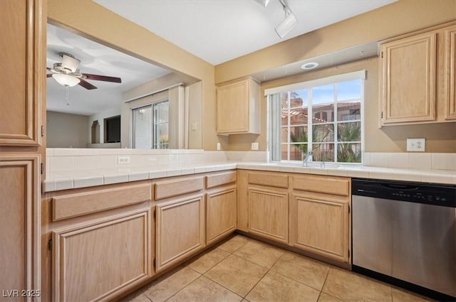 kitchen with ceiling fan, light tile patterned floors, a peninsula, light brown cabinetry, and dishwasher
