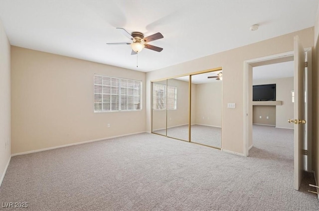 unfurnished bedroom with ceiling fan, baseboards, a closet, and carpet
