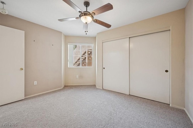 unfurnished bedroom featuring baseboards, carpet floors, a closet, and ceiling fan