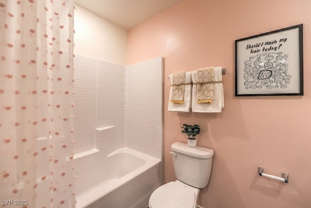 bathroom featuring toilet and shower / tub combo with curtain