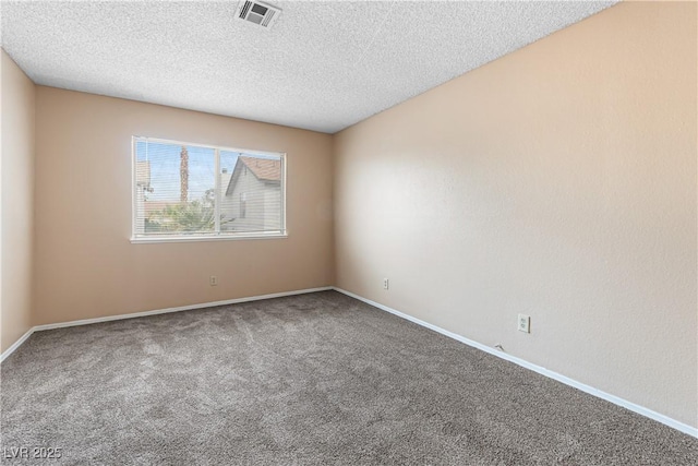 carpeted empty room with visible vents, baseboards, and a textured ceiling