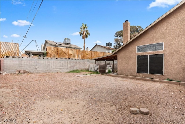 view of yard with central air condition unit and a fenced backyard