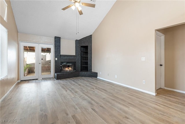 unfurnished living room featuring baseboards, ceiling fan, french doors, light wood-style floors, and high vaulted ceiling