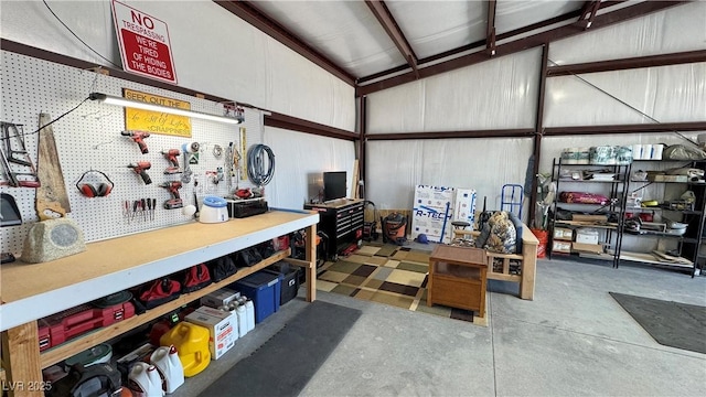 garage featuring a workshop area and metal wall