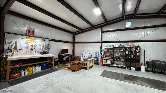 garage featuring a workshop area and metal wall