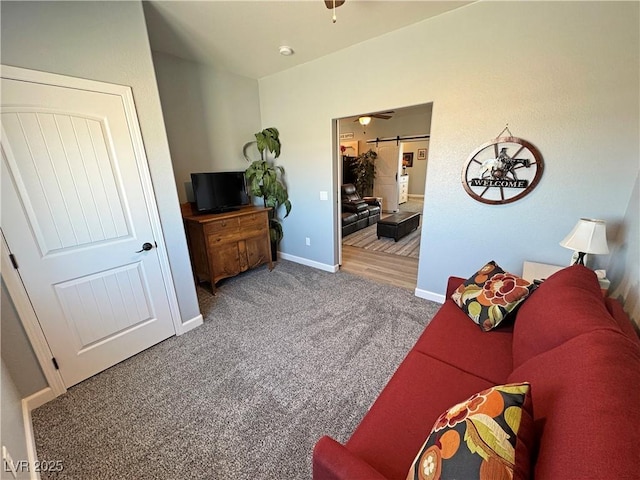 living area with baseboards and carpet