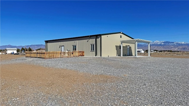 back of house featuring a mountain view and a pergola