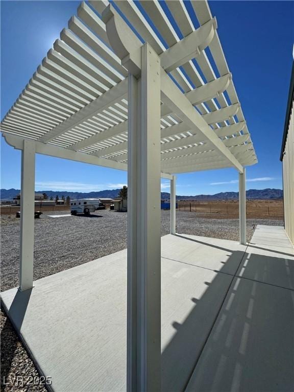 view of patio featuring a mountain view and a pergola