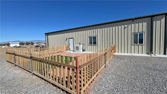 exterior space featuring ac unit, fence, and a mountain view