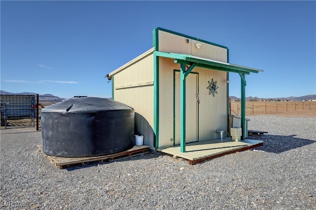 view of outbuilding with an outbuilding and fence