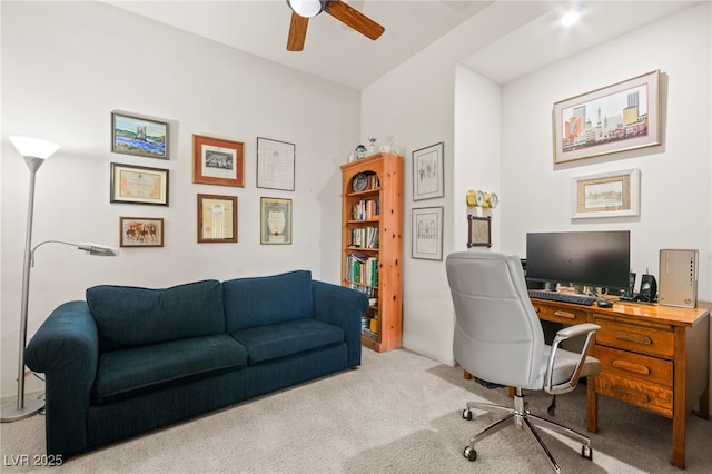 carpeted office space featuring a ceiling fan