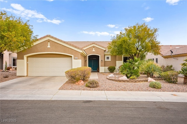 view of front of house featuring stucco siding, an attached garage, driveway, and a tiled roof