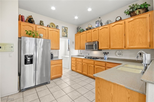 kitchen with light countertops, light tile patterned floors, recessed lighting, stainless steel appliances, and a sink