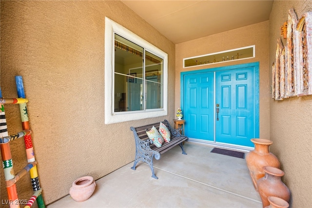 entrance to property with stucco siding