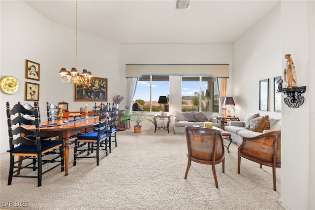 carpeted living area featuring visible vents, a high ceiling, and an inviting chandelier