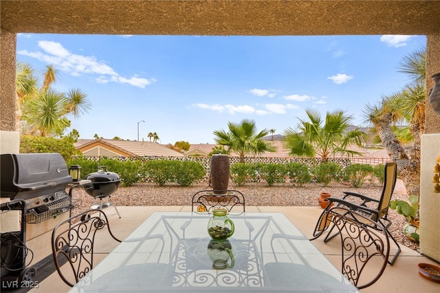 view of patio / terrace with grilling area and fence