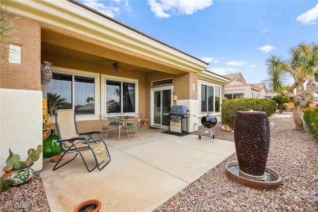 view of patio with outdoor dining area, area for grilling, and ceiling fan