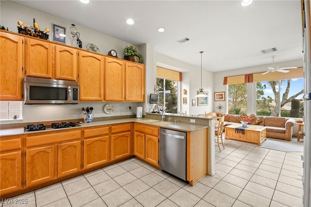 kitchen featuring a sink, visible vents, appliances with stainless steel finishes, and light countertops