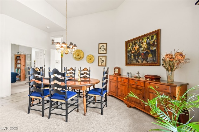 dining room with light carpet, light tile patterned floors, and a chandelier