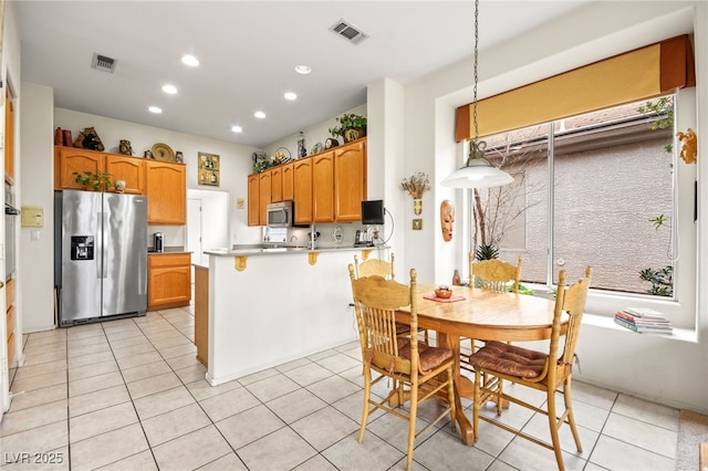 kitchen with light tile patterned floors, visible vents, a peninsula, recessed lighting, and appliances with stainless steel finishes