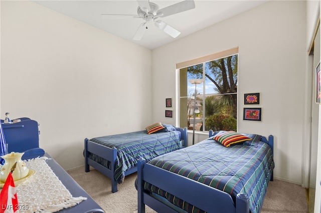 bedroom featuring baseboards, light carpet, and ceiling fan