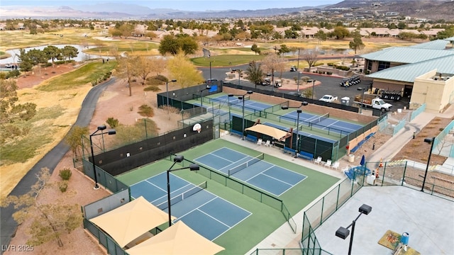 birds eye view of property with a mountain view and view of golf course