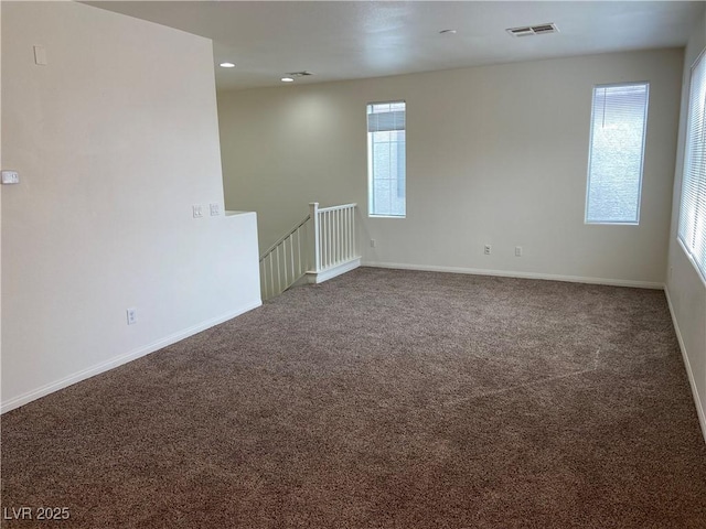 carpeted empty room with recessed lighting, visible vents, and baseboards