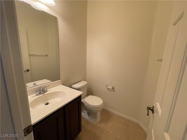 bathroom with tile patterned floors, toilet, vanity, and baseboards