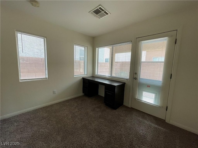 unfurnished office with visible vents, baseboards, and carpet