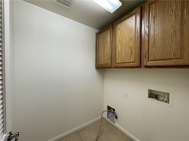 laundry room with visible vents, baseboards, washer hookup, light tile patterned floors, and cabinet space