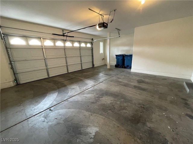 garage with baseboards and a garage door opener