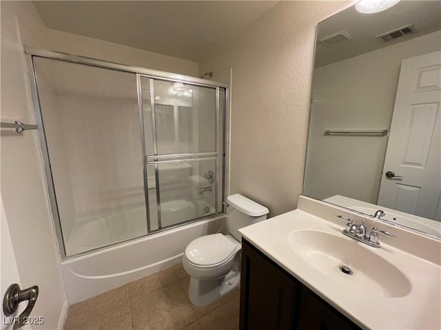 bathroom featuring vanity, tile patterned floors, toilet, and visible vents