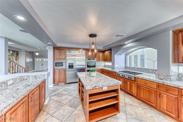 kitchen featuring built in appliances, brown cabinets, visible vents, and open shelves