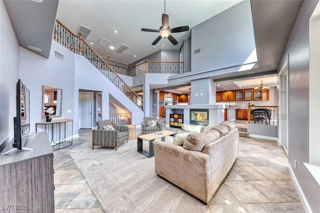 living room with visible vents, baseboards, and a ceiling fan