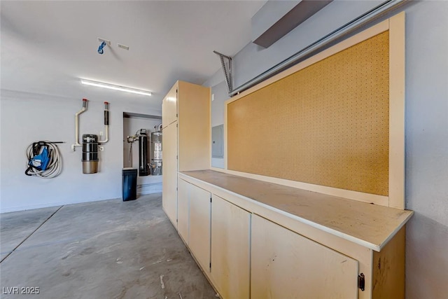 garage with strapped water heater and electric panel