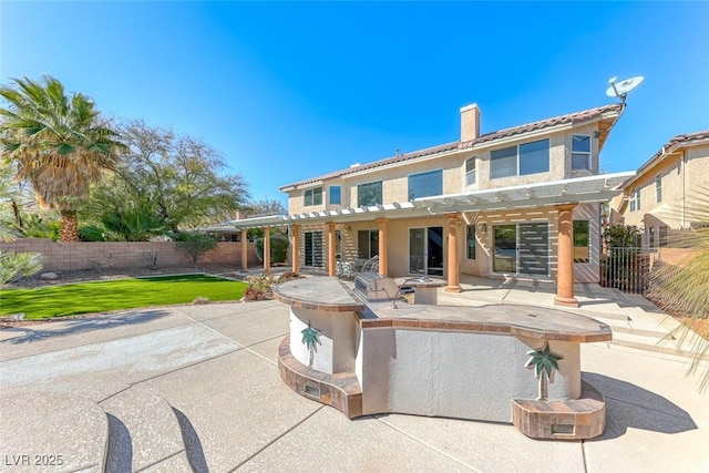 rear view of property with a fenced backyard, a pergola, a chimney, a patio area, and a lawn