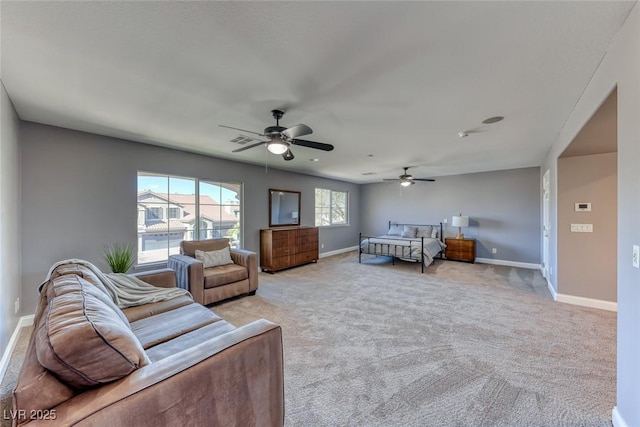 bedroom with visible vents, baseboards, light colored carpet, and ceiling fan