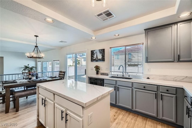 kitchen with visible vents, plenty of natural light, gray cabinetry, and a sink