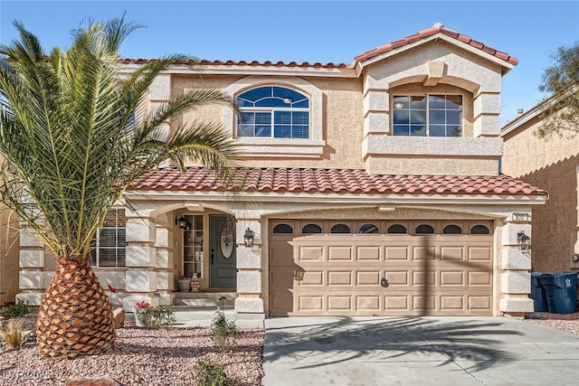 mediterranean / spanish home with a tile roof, concrete driveway, an attached garage, and stucco siding