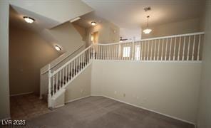 staircase with baseboards and carpet floors