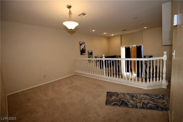 carpeted empty room featuring visible vents, recessed lighting, and baseboards