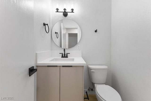 bathroom with toilet and vanity