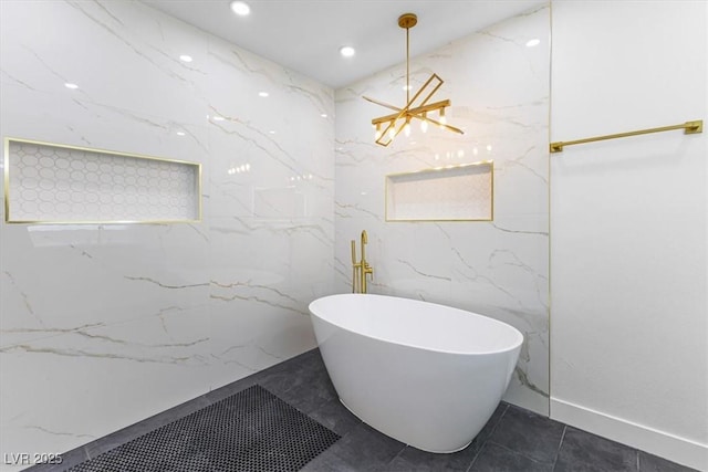full bath featuring a chandelier, a soaking tub, and recessed lighting