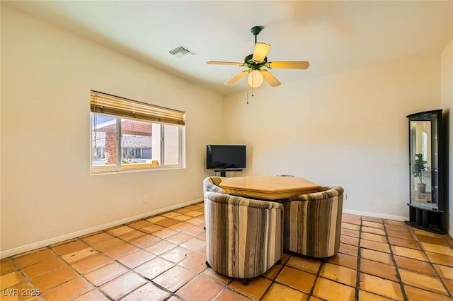 unfurnished office with light tile patterned floors, visible vents, baseboards, and a ceiling fan