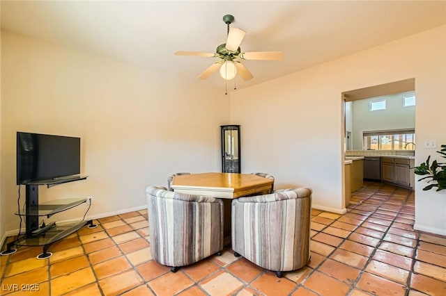 dining room featuring light tile patterned flooring, a ceiling fan, and baseboards