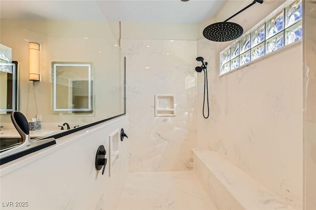 bathroom featuring a marble finish shower and vanity