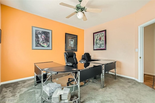 office space featuring baseboards, carpet floors, and a ceiling fan