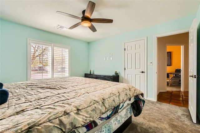 bedroom with carpet flooring, a ceiling fan, visible vents, and baseboards